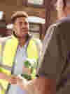 A volunteer deliverying medication to someone at their home