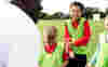 Volunteering with young children providing sports 