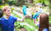 Two community volunteers high fiving in a field